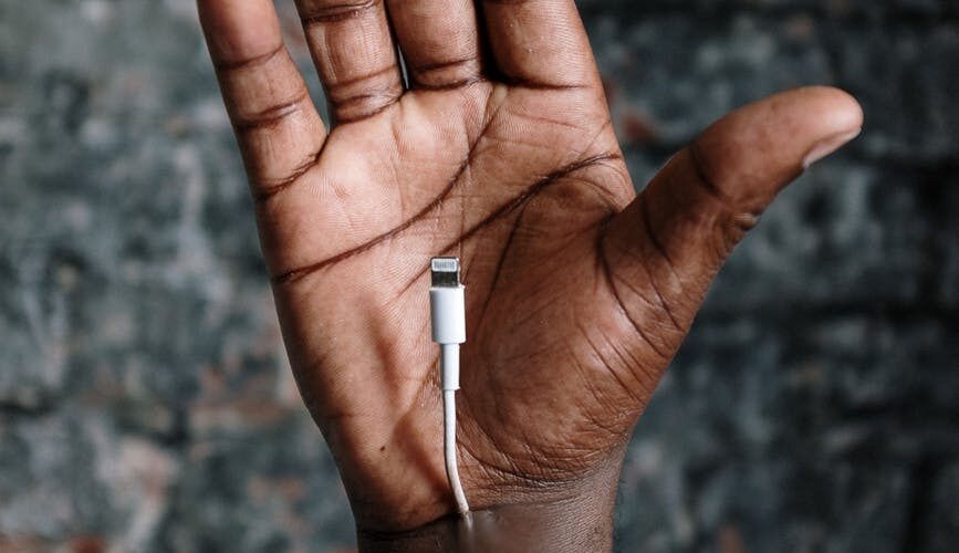person with white lightning to usb cable