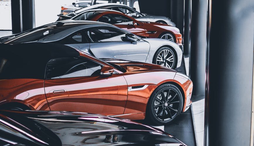 five assorted color cars parked inside room